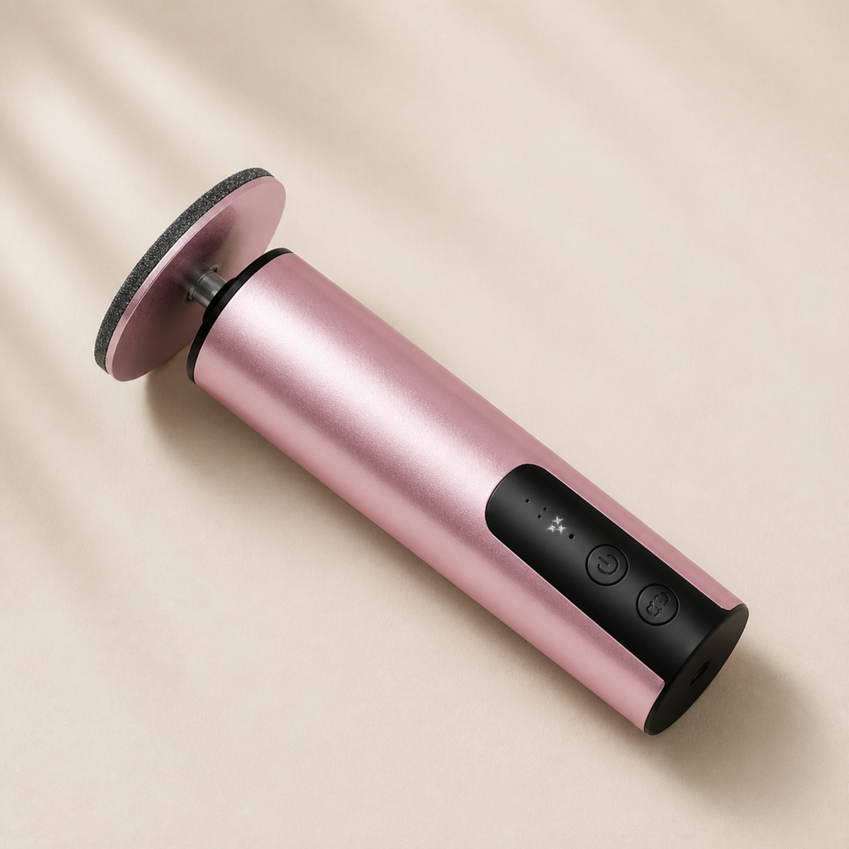 Pink electric foot callus remover with a sanding disc attached